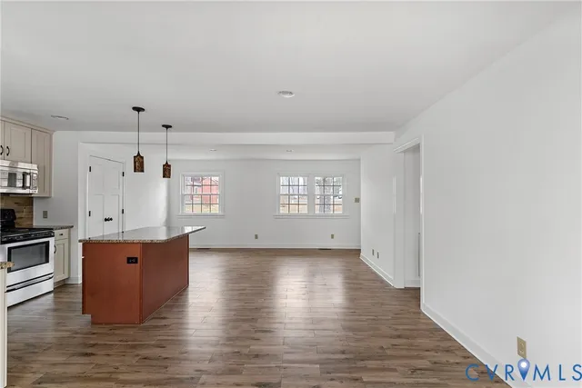 a bathroom with a granite countertop sink a mirror and a bathtub