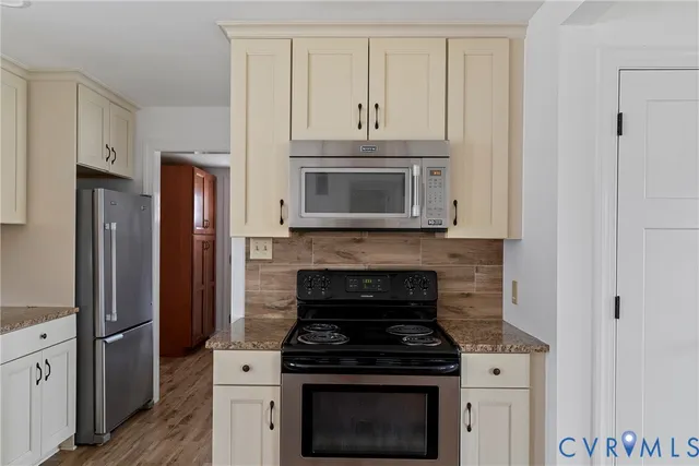 a view of hallway with wooden floor