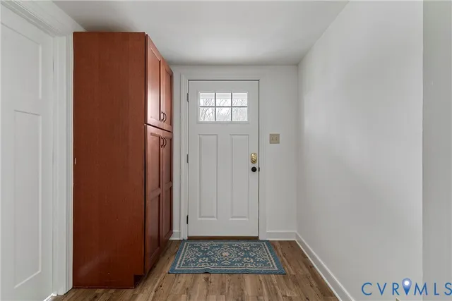a kitchen with granite countertop white cabinets and sink