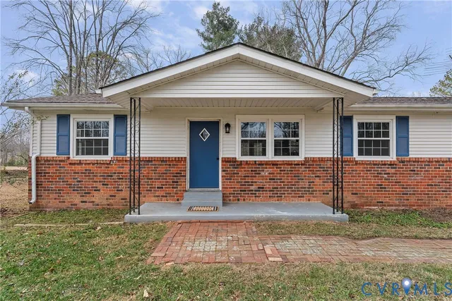 front view of a brick house with a large windows