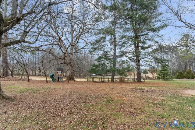 a view of a house with a yard covered in snow