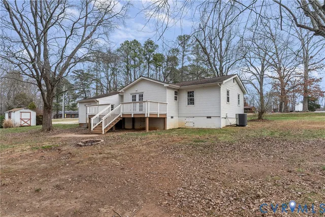 a view of a backyard with wooden fence