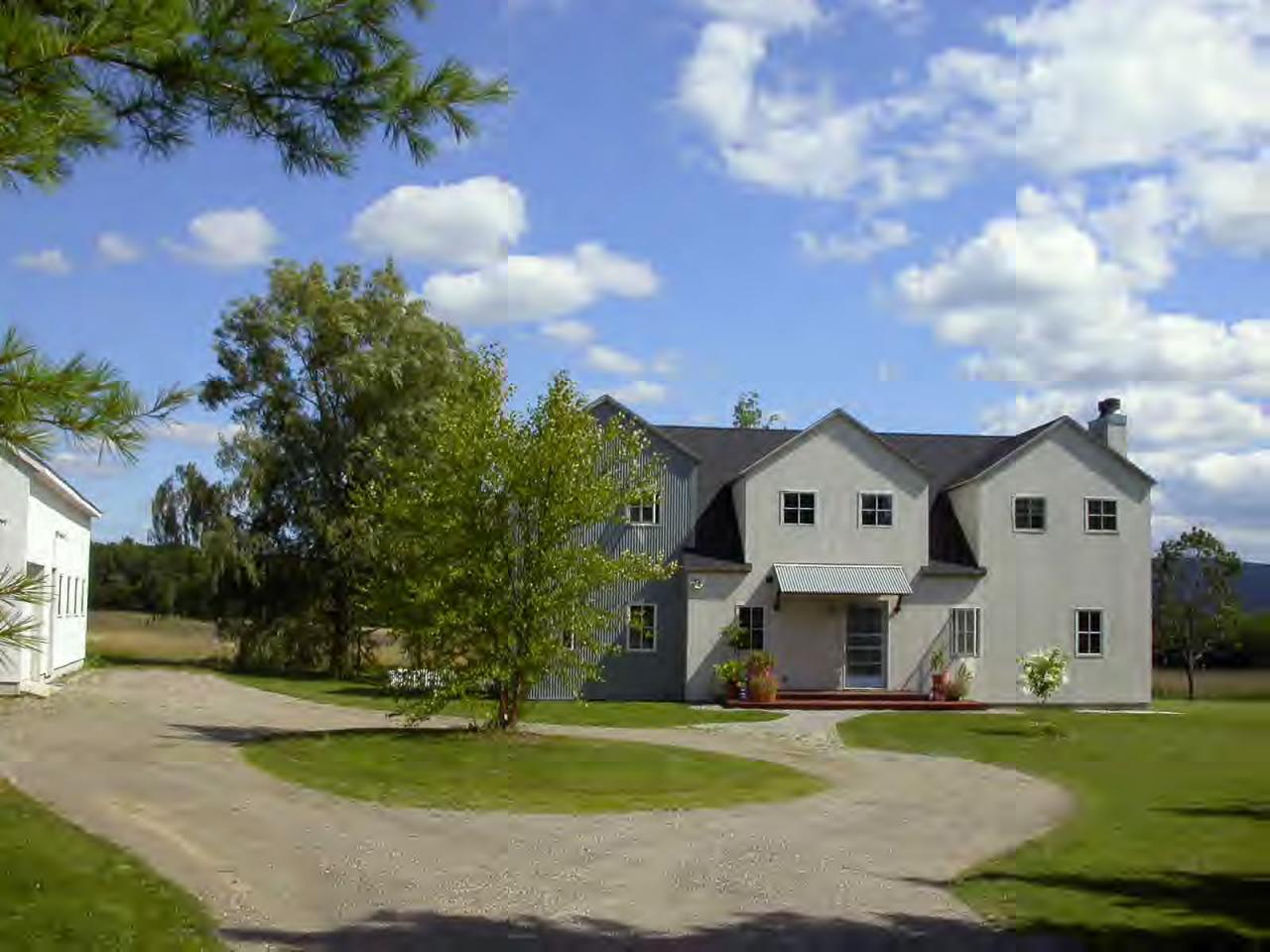 34 Prospect Hill Road Stockbridge, MA 01262 - Photo 1 of 12 a view of a white house with a big yard and a large trees