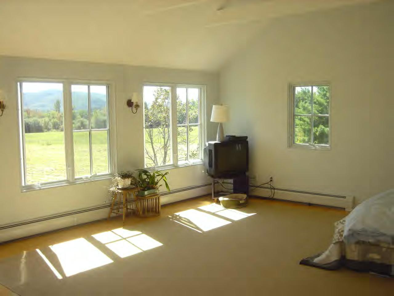34 Prospect Hill Road Stockbridge, MA 01262 - Photo 8 of 12 a living room with furniture a rug and a floor to ceiling window