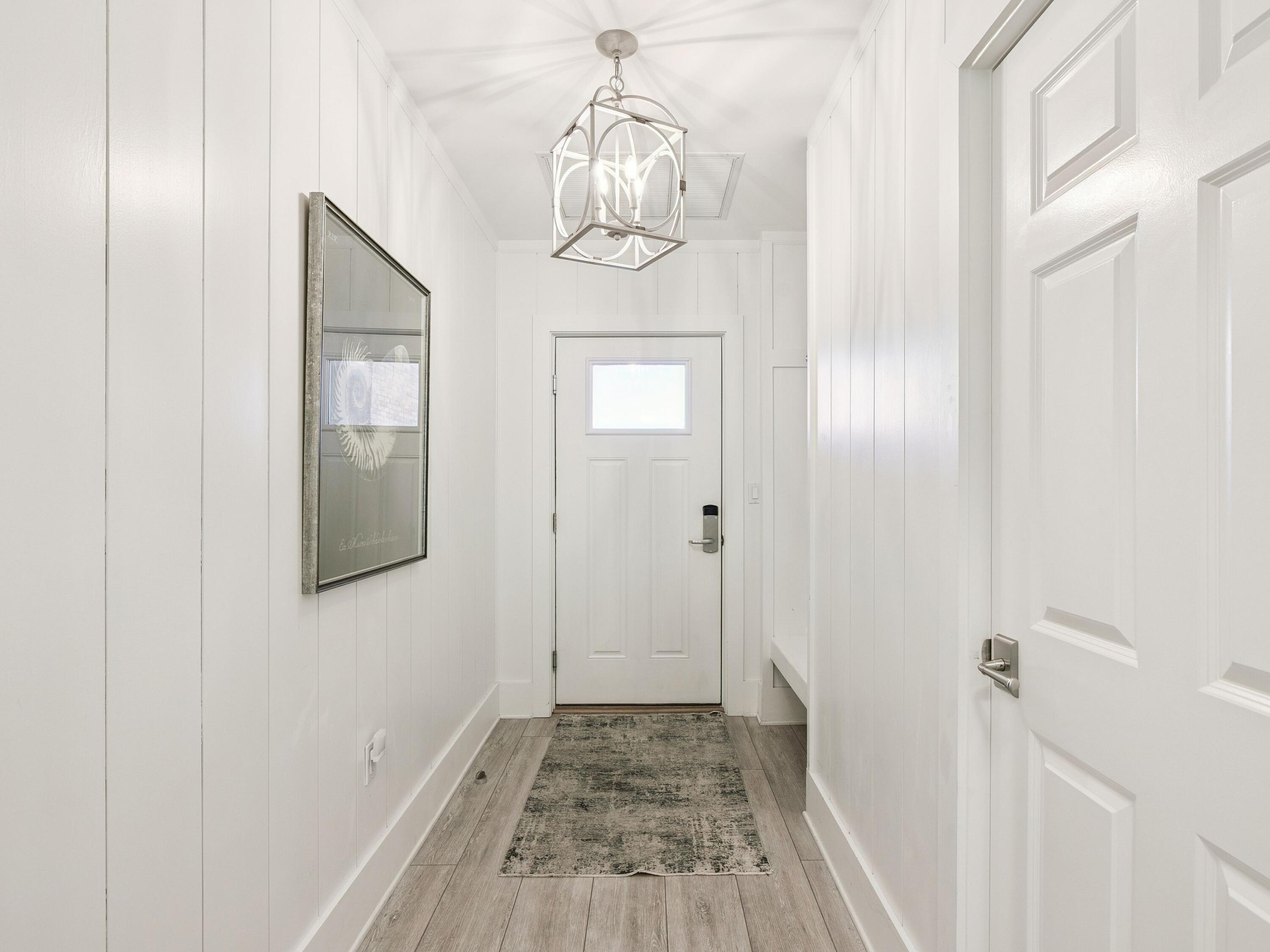 56 Blue Mountain Road, Unit B304 Santa Rosa Beach, FL 32459 - Photo 12 of 47 a view of a hallway with wooden floor and staircase