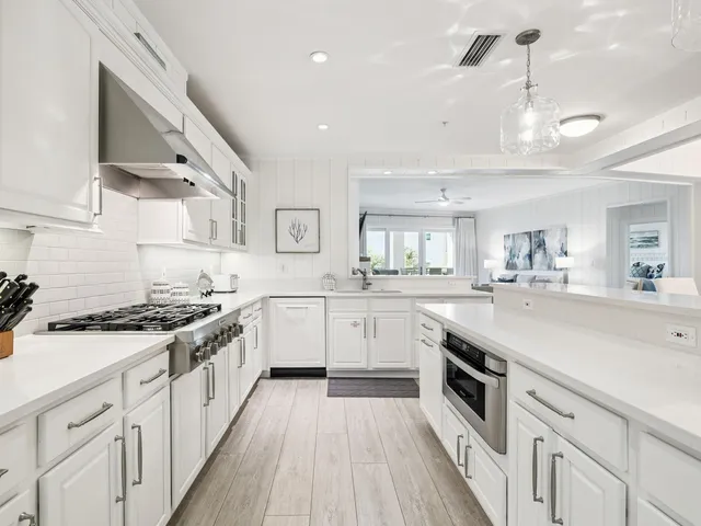 a kitchen with sink cabinets and stove top oven