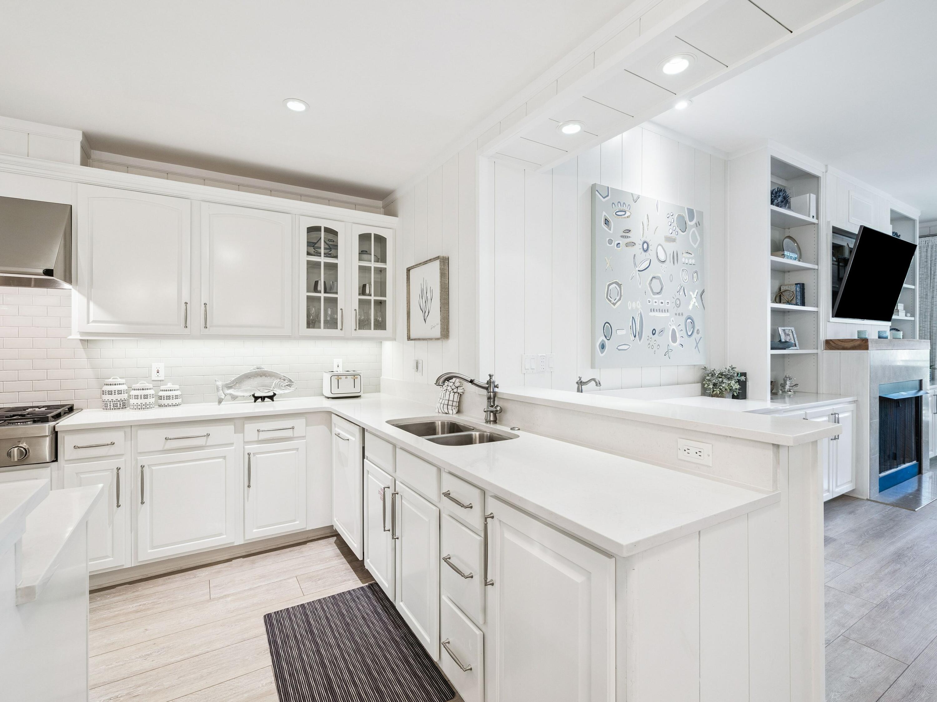 56 Blue Mountain Road, Unit B304 Santa Rosa Beach, FL 32459 - Photo 15 of 47 a kitchen with white cabinets sink and stove