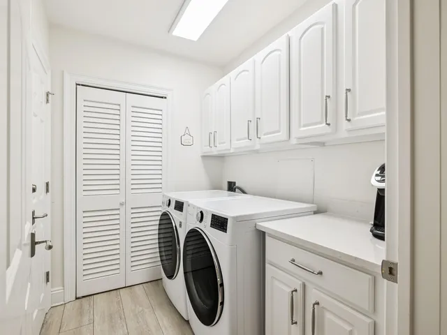 a bathroom with a toilet sink vanity and mirror