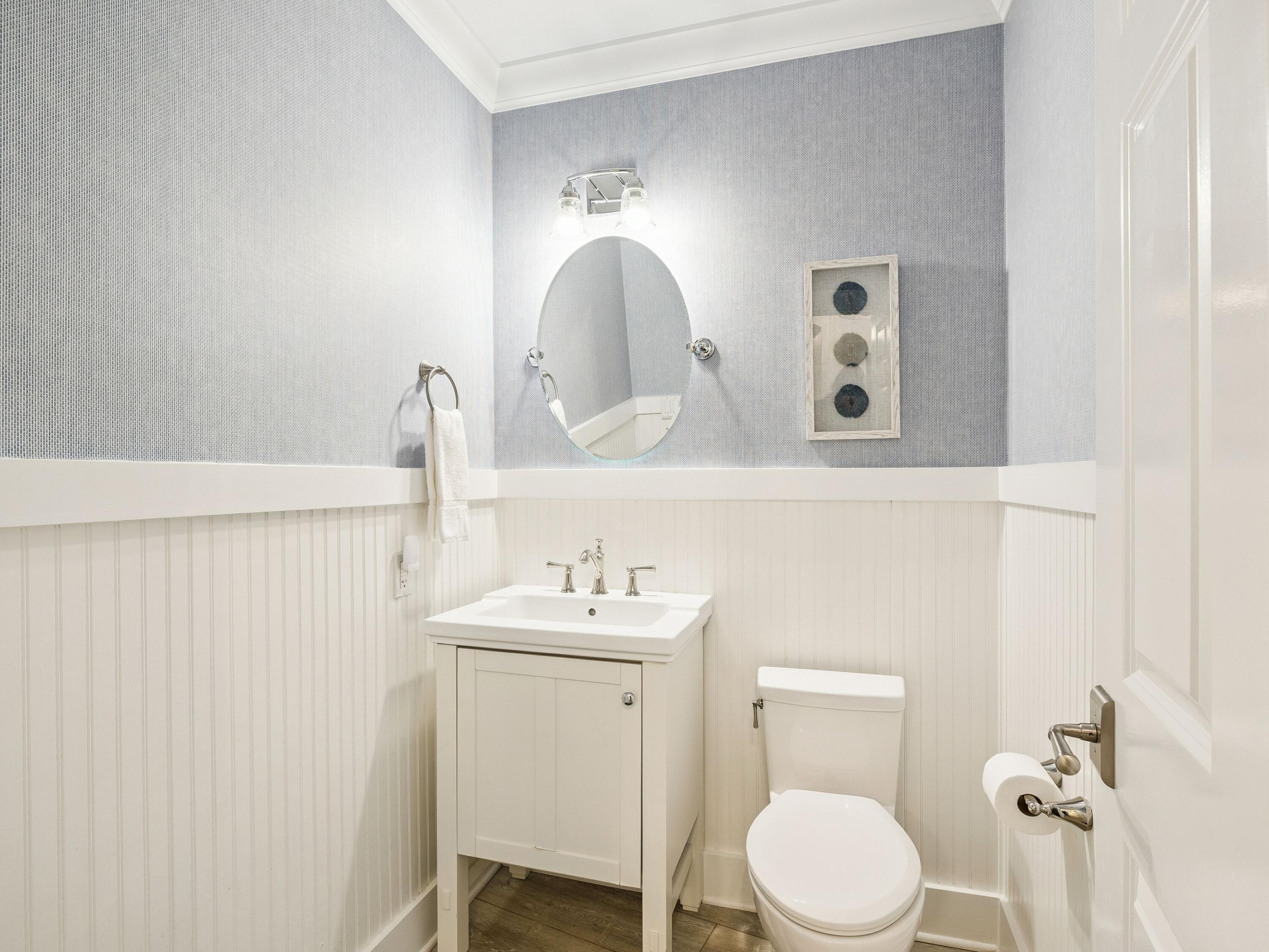 56 Blue Mountain Road, Unit B304 Santa Rosa Beach, FL 32459 - Photo 18 of 47 a bathroom with a toilet sink vanity and mirror