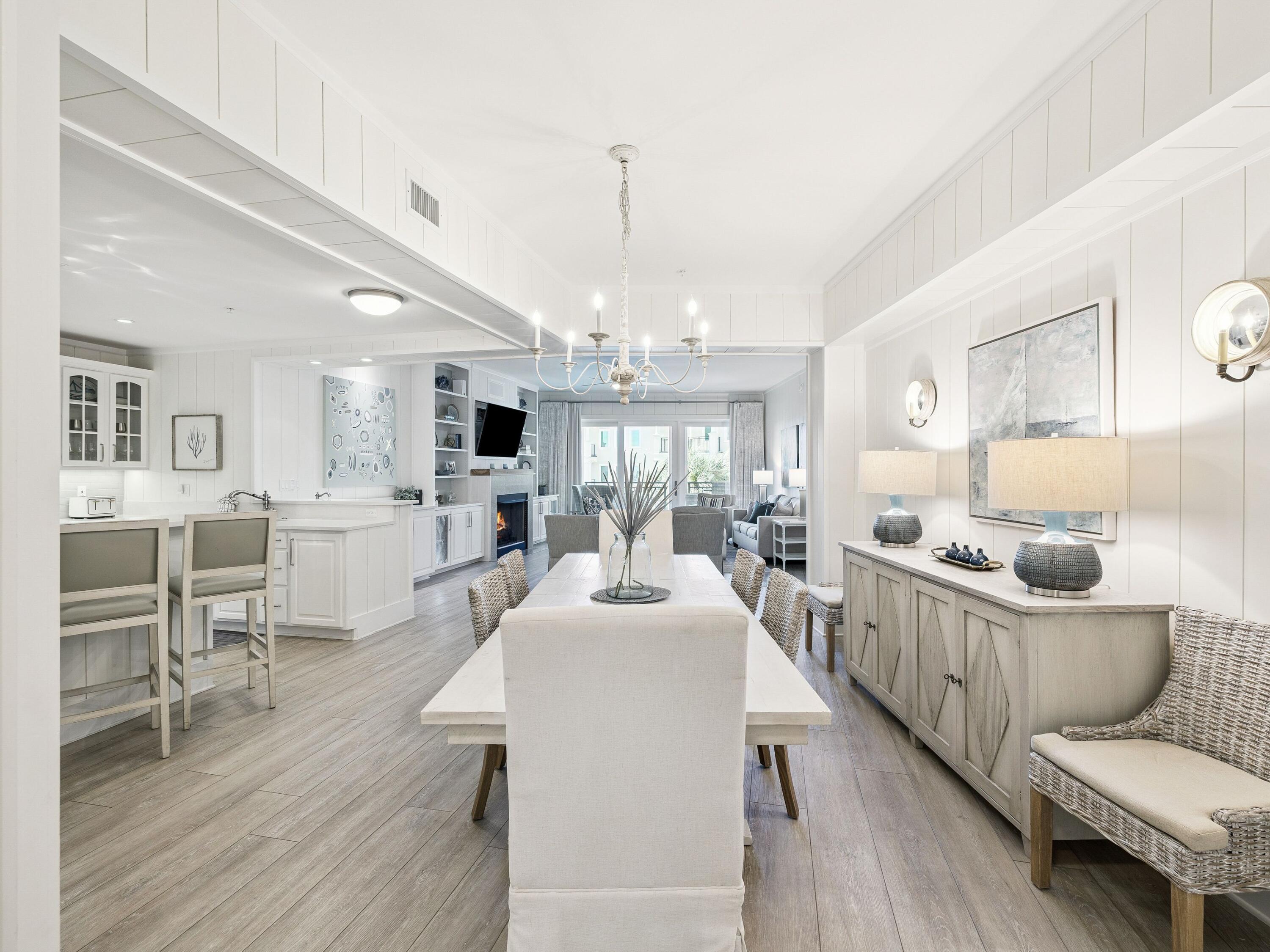 56 Blue Mountain Road, Unit B304 Santa Rosa Beach, FL 32459 - Photo 3 of 47 a room with stainless steel appliances a dining table wooden floor and a fireplace