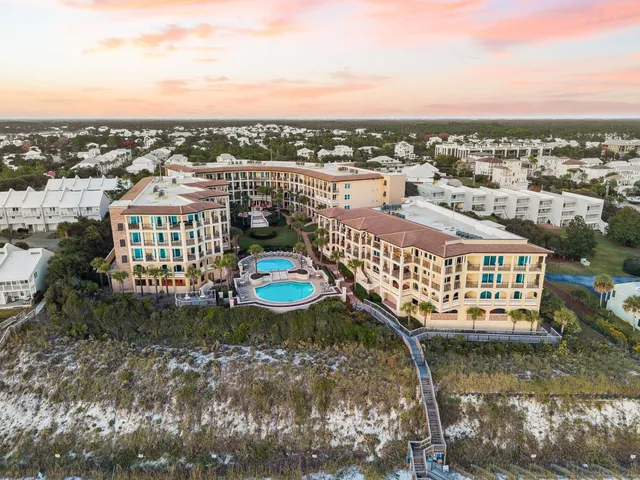 a view of a swimming pool with outdoor seating and plants