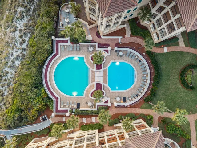 a view of a swimming pool with a patio and a yard