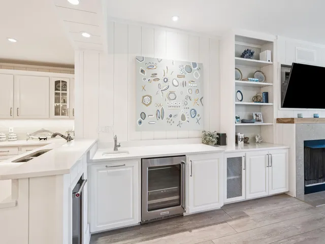 a view of cabinets with stainless steel appliances granite countertop a stove and a sink