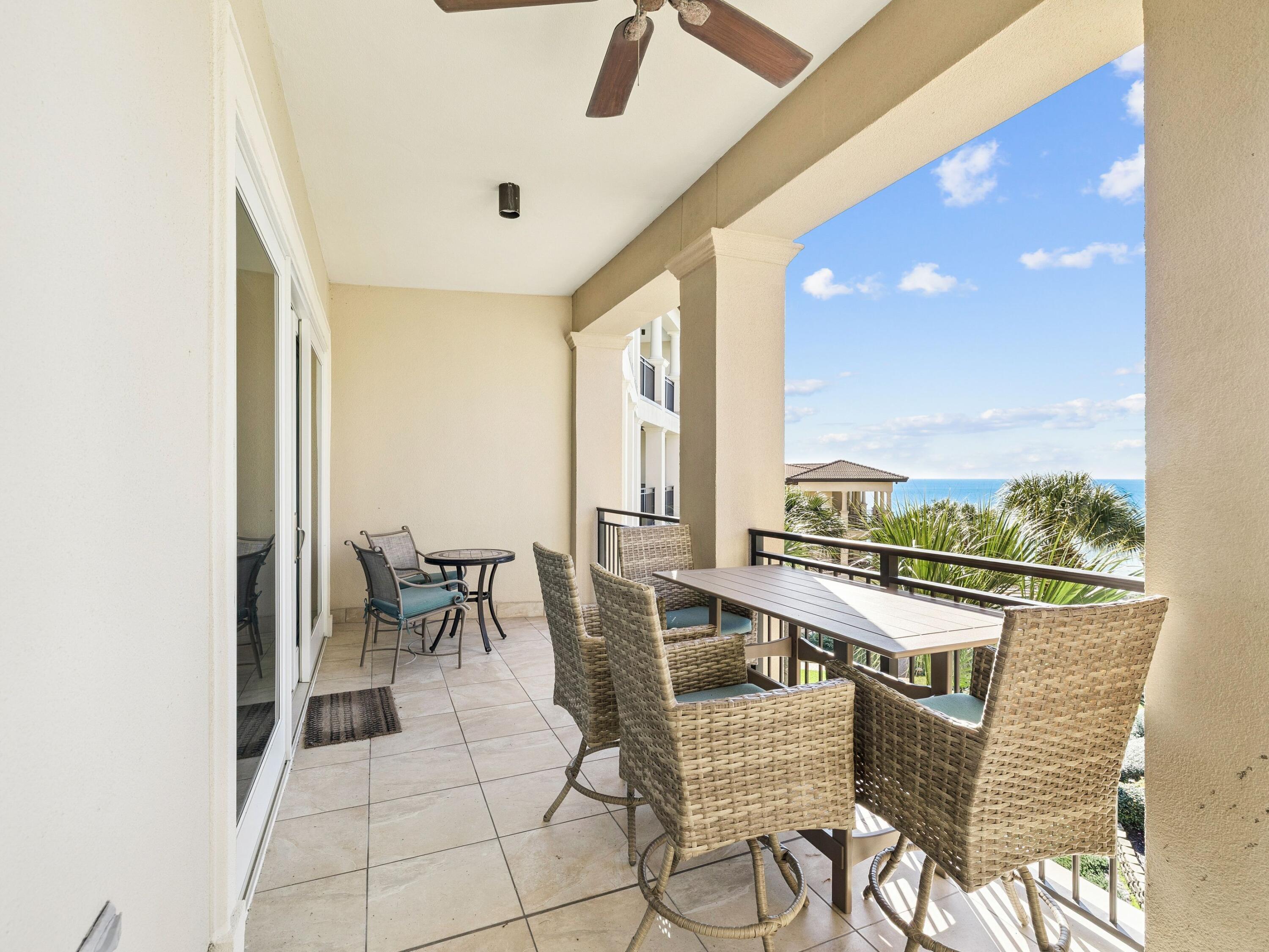 56 Blue Mountain Road, Unit B304 Santa Rosa Beach, FL 32459 - Photo 9 of 47 a view of a dining room with furniture and floor to ceiling window