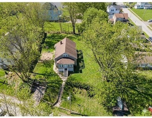 an aerial view of a house with a yard