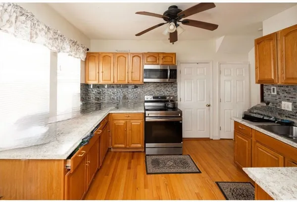 a kitchen with stainless steel appliances granite countertop a stove and a sink