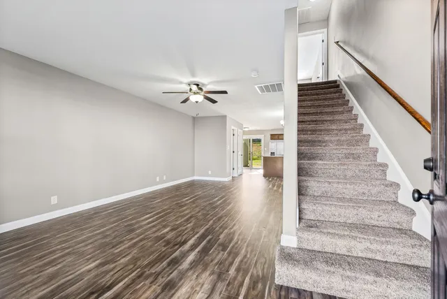 a view of entryway and hall with wooden floor