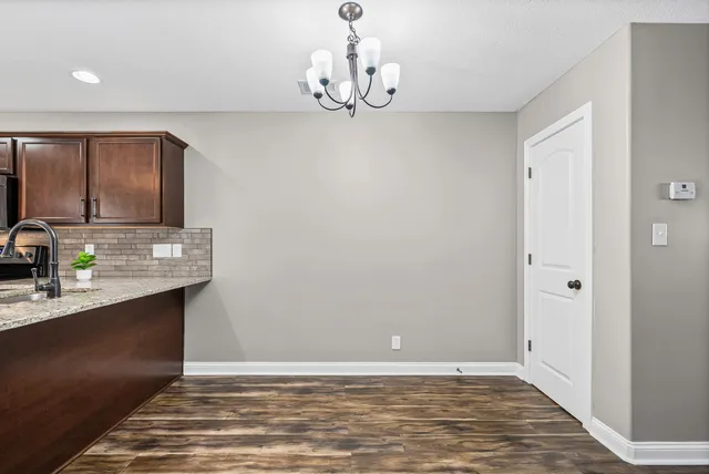 a view of kitchen with granite countertop cabinets and wooden floor