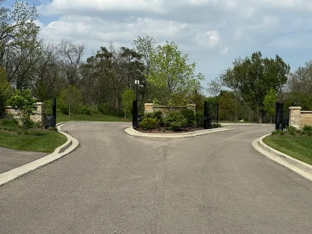 a view of a street with a houses in the background