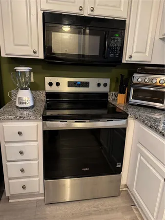 a view of a kitchen with a sink and a stove