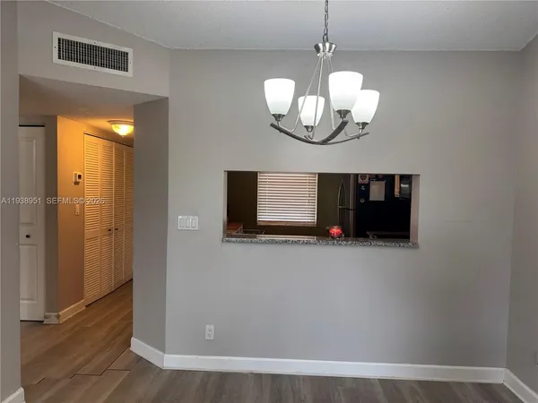 a sign of golf club on a wall under a tree