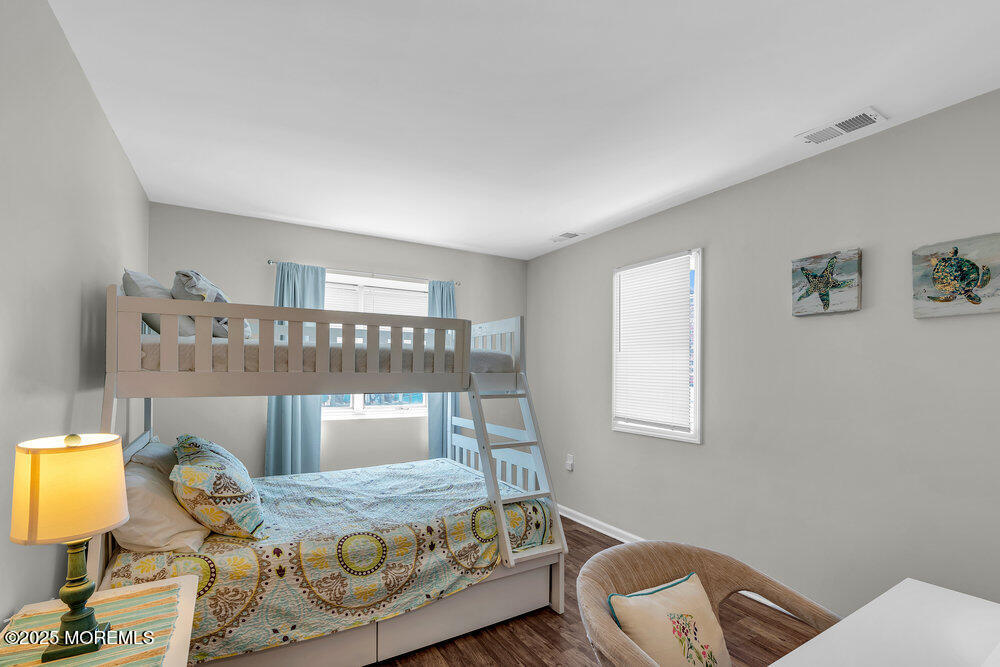 62 Sherman Avenue, Unit A1 Seaside Heights, NJ 08751 - Photo 12 of 17 a bedroom with a bed and window