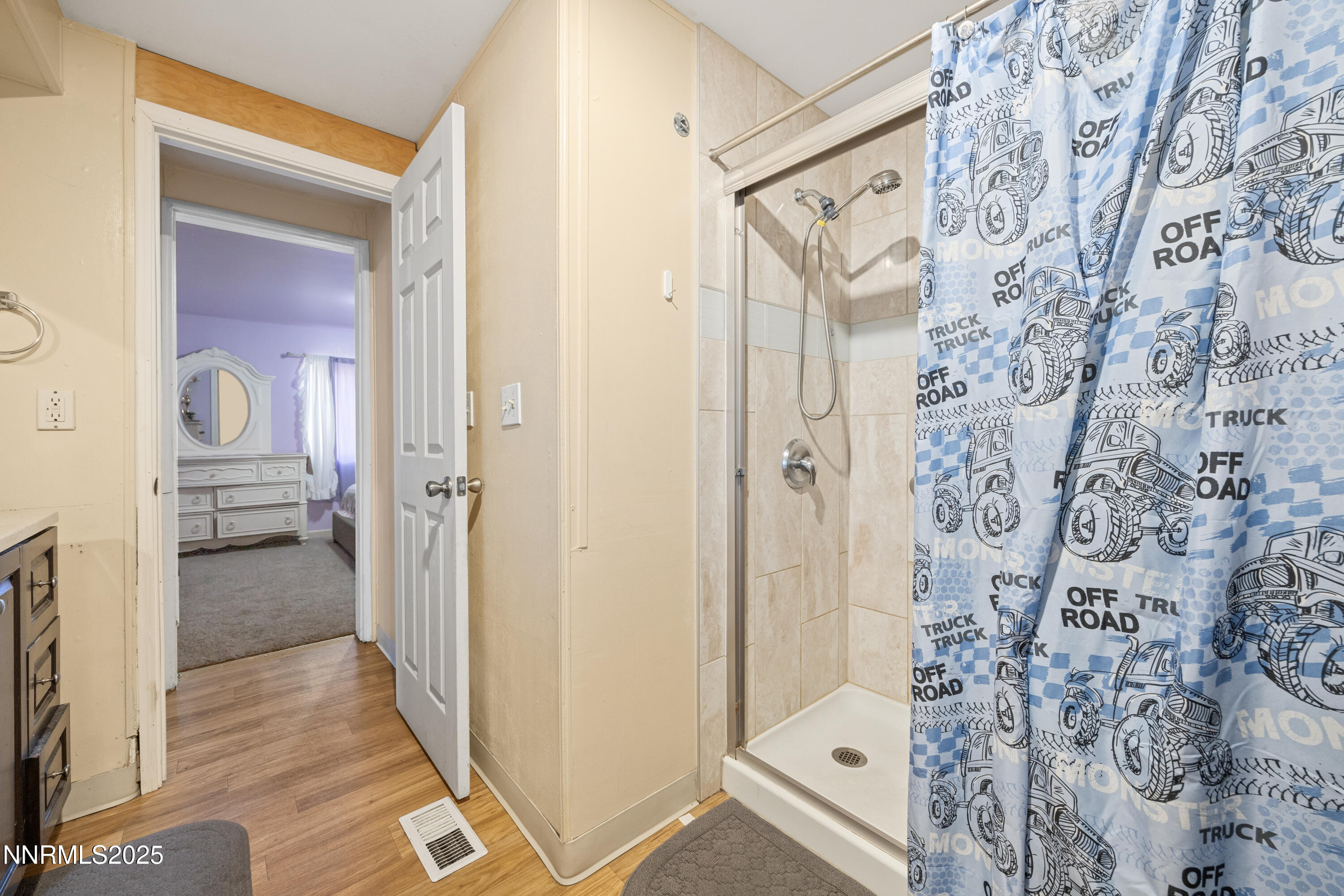 2735 Daffodil Way Reno, NV 89512 - Photo 18 of 23 a bathroom with a glass shower door