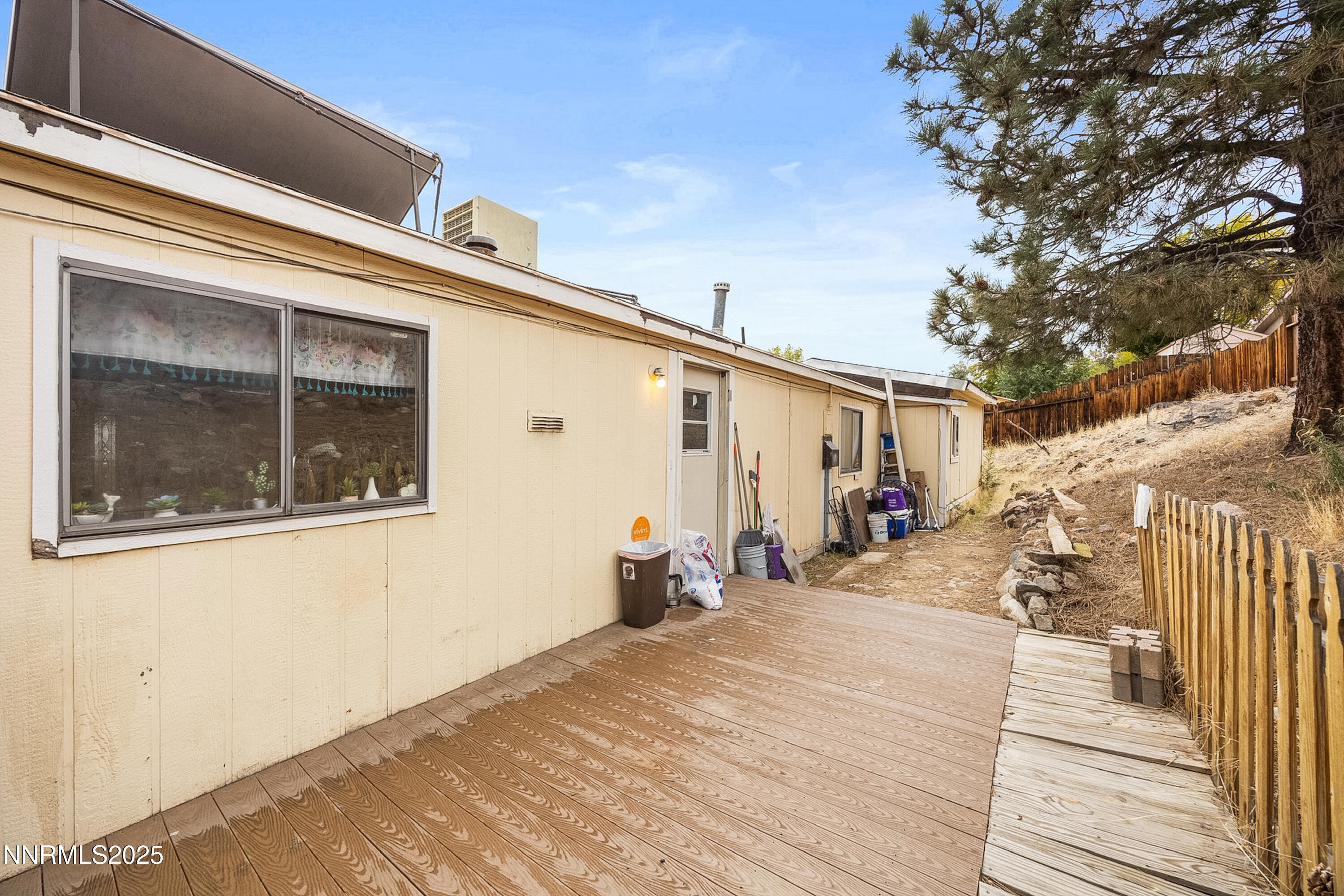 2735 Daffodil Way Reno, NV 89512 - Photo 23 of 23 a view of a house with a barbeque and wooden stairs