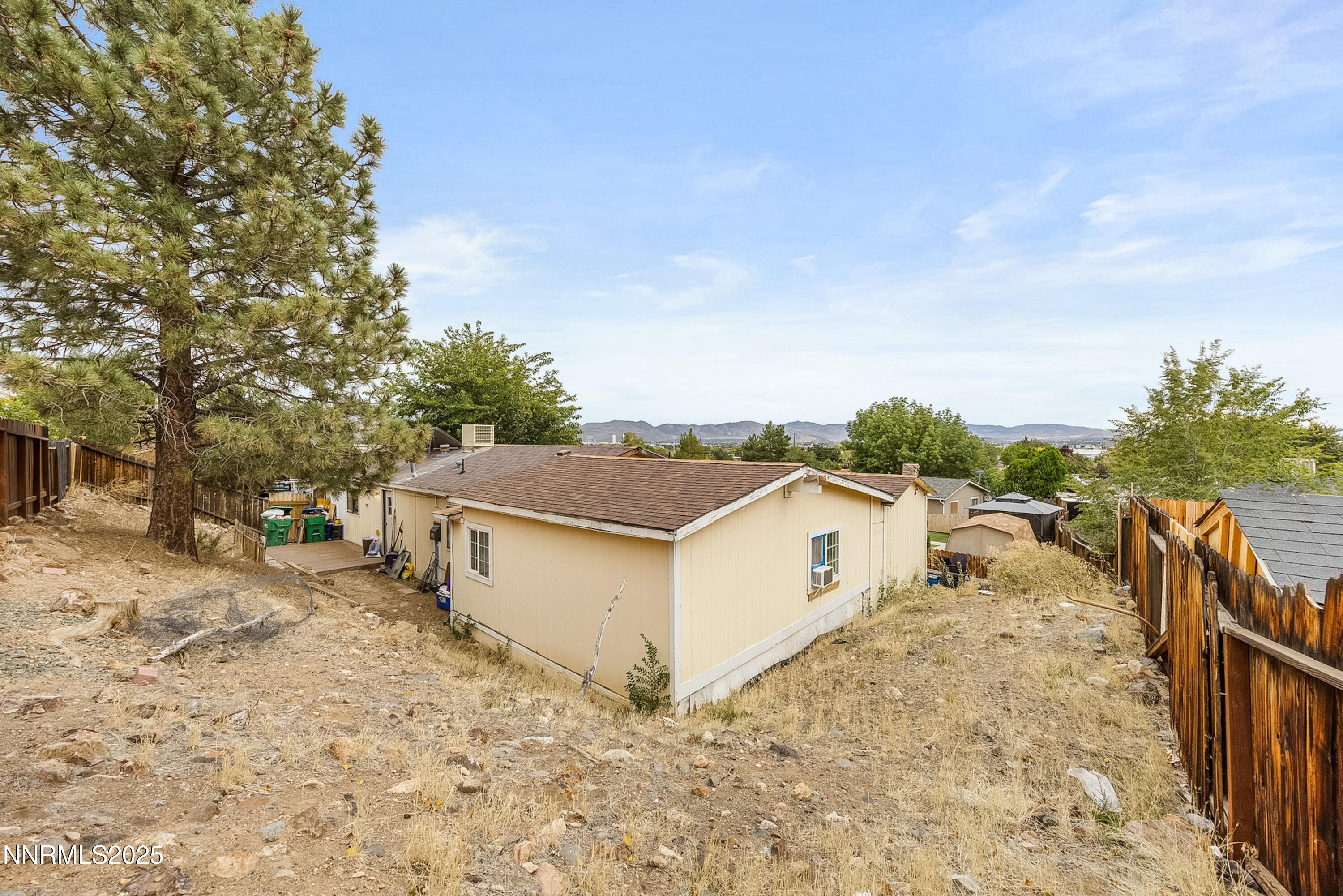 2735 Daffodil Way Reno, NV 89512 - Photo 3 of 23 a view of a dry yard with wooden fence