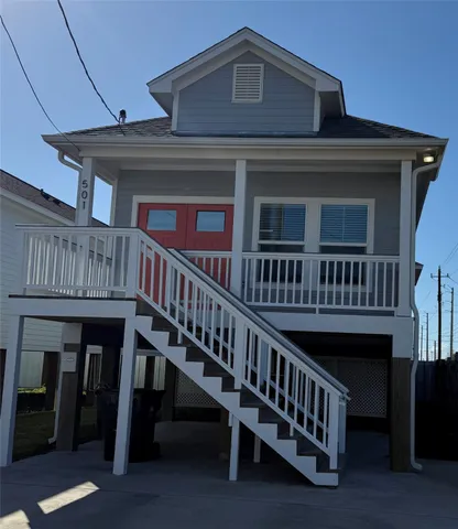 a view of a house with wooden deck front of house