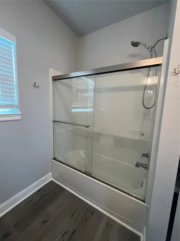 a bathroom with a glass shower door