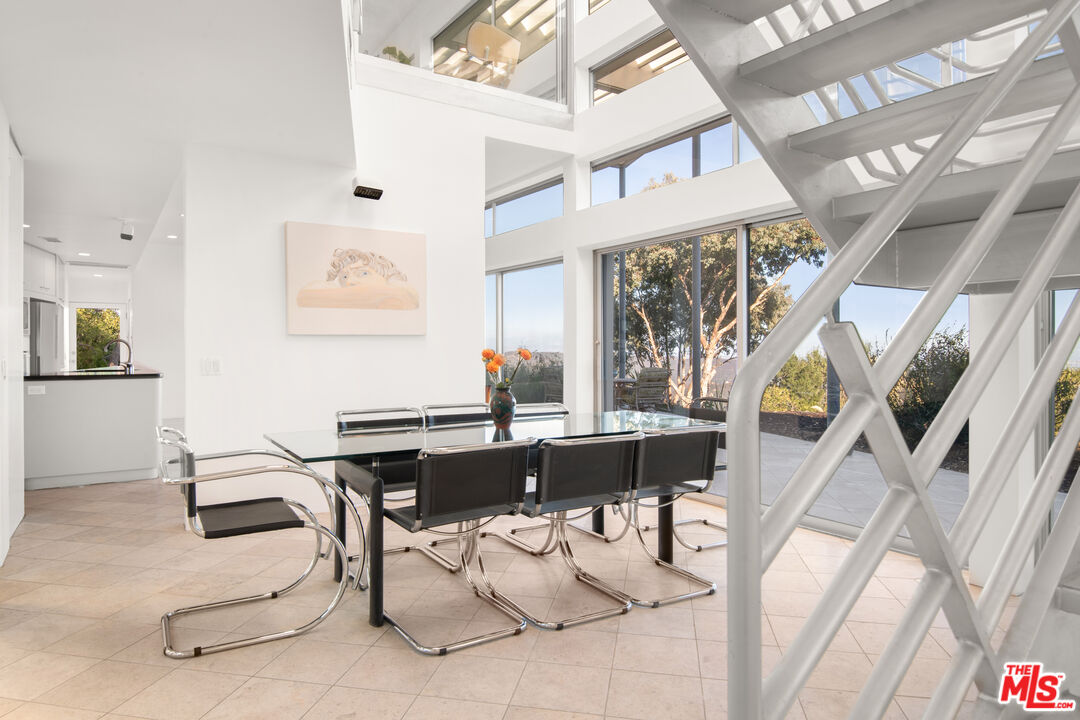 21839 Saddle Peak Road Topanga, CA 90290 - Photo 11 of 72 a view of a dining room with furniture window and wooden floor