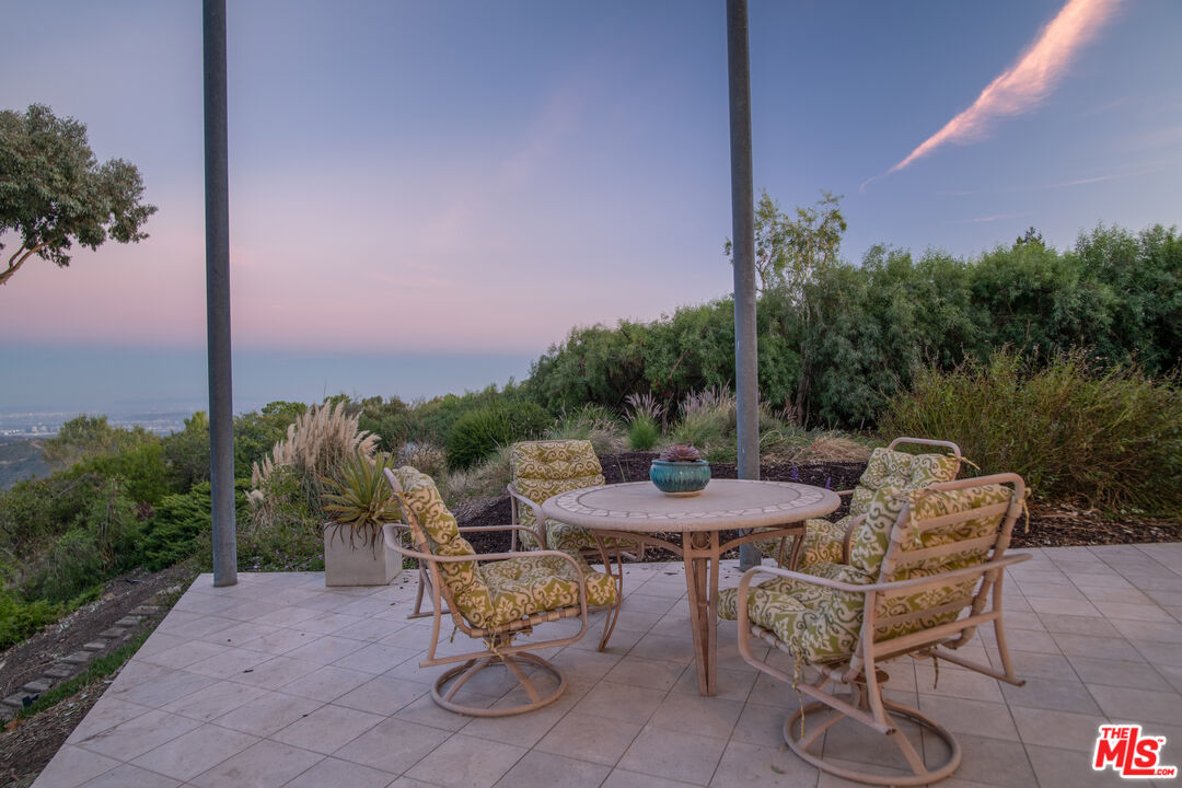 21839 Saddle Peak Road Topanga, CA 90290 - Photo 16 of 72 a view of a patio with furniture and a yard