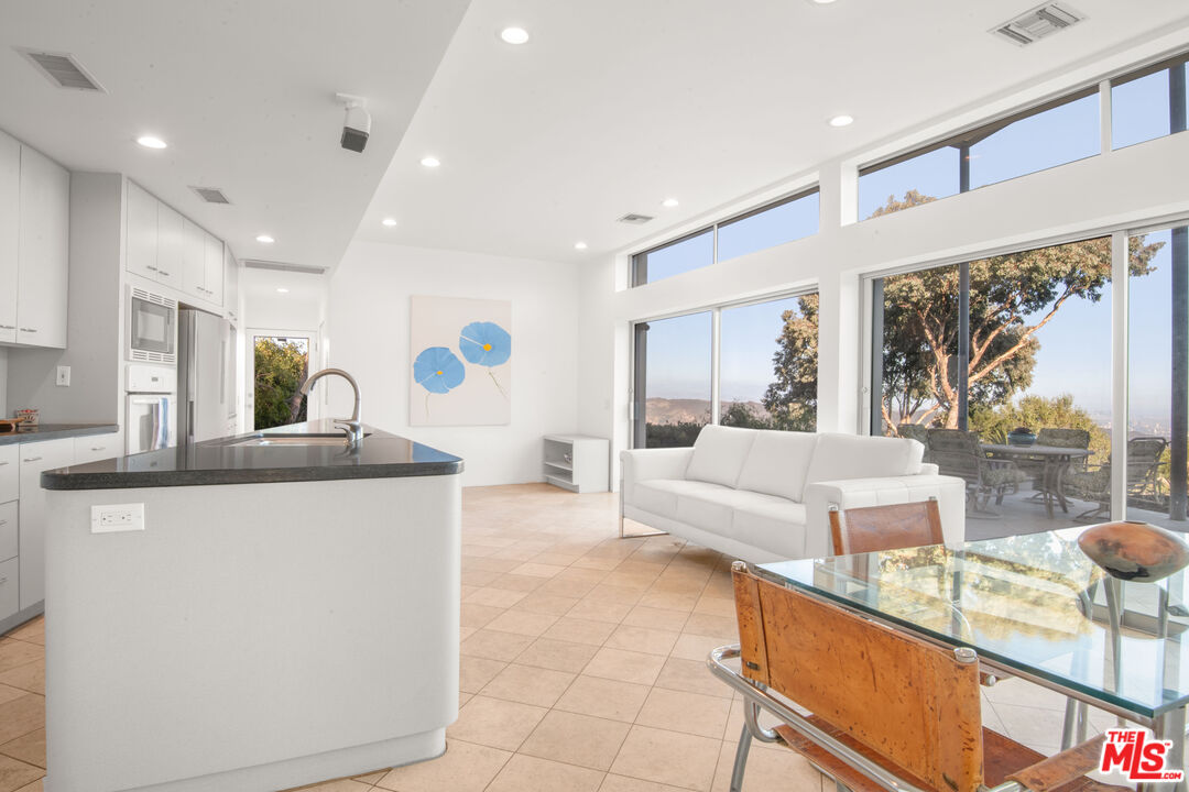 21839 Saddle Peak Road Topanga, CA 90290 - Photo 18 of 72 a living room with granite countertop furniture and a large window