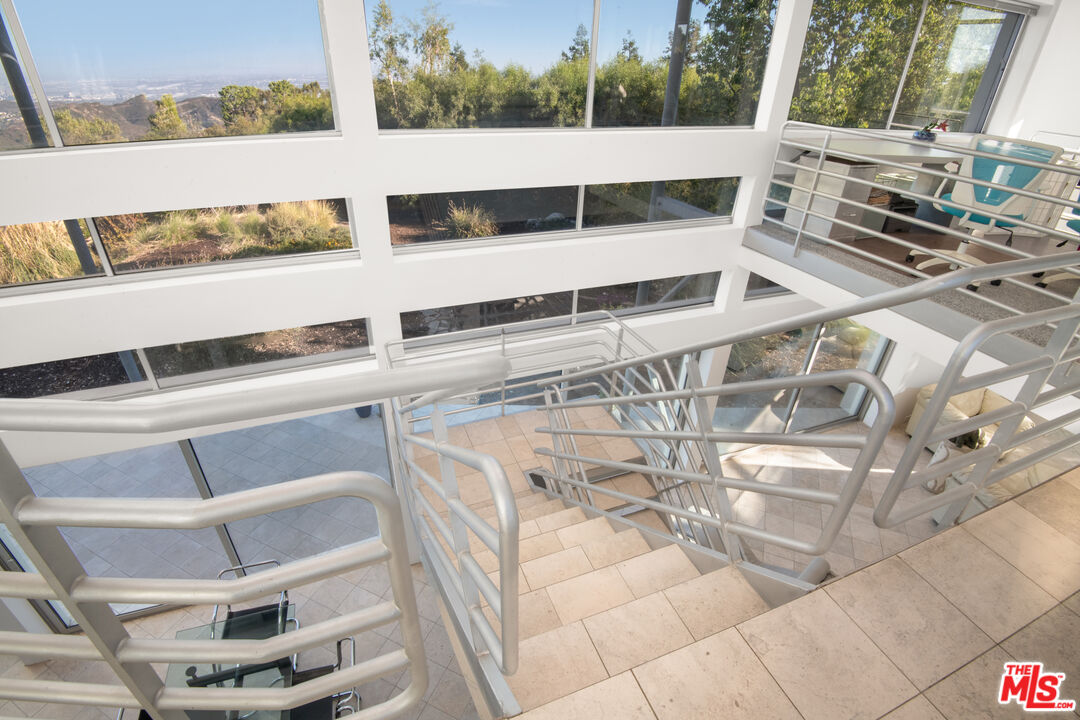 21839 Saddle Peak Road Topanga, CA 90290 - Photo 19 of 72 a view of a balcony with table and chairs