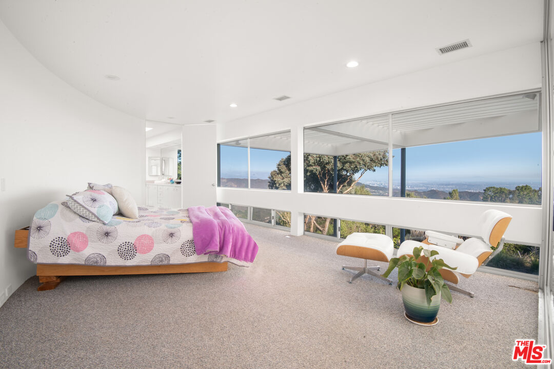 21839 Saddle Peak Road Topanga, CA 90290 - Photo 22 of 72 a bed room with bed and window