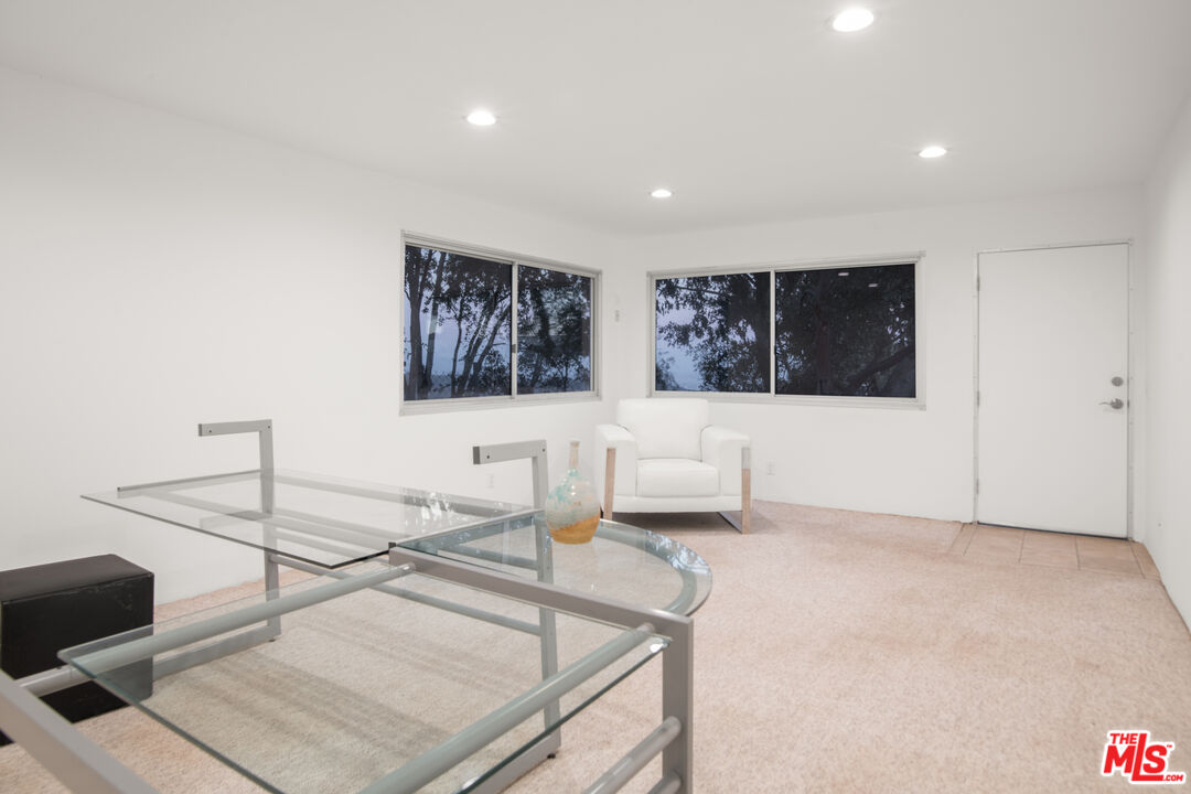 21839 Saddle Peak Road Topanga, CA 90290 - Photo 38 of 72 a living room with furniture and white walls