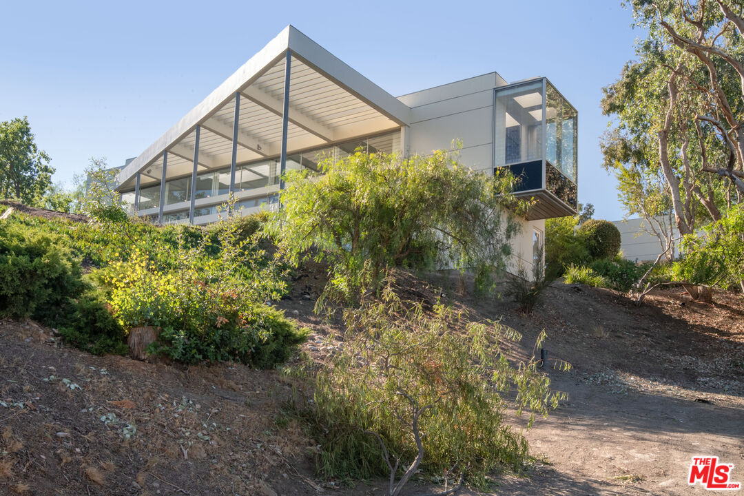 21839 Saddle Peak Road Topanga, CA 90290 - Photo 50 of 72 a view of a house with a yard and plants