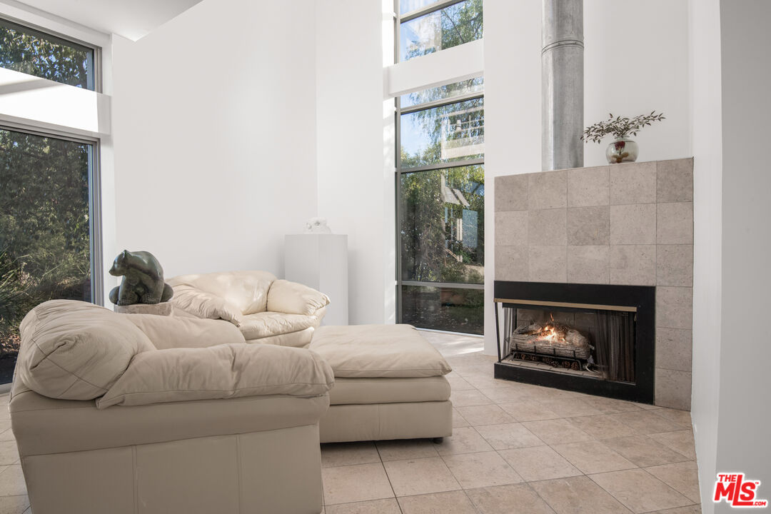 21839 Saddle Peak Road Topanga, CA 90290 - Photo 8 of 72 a living room with furniture and a fireplace