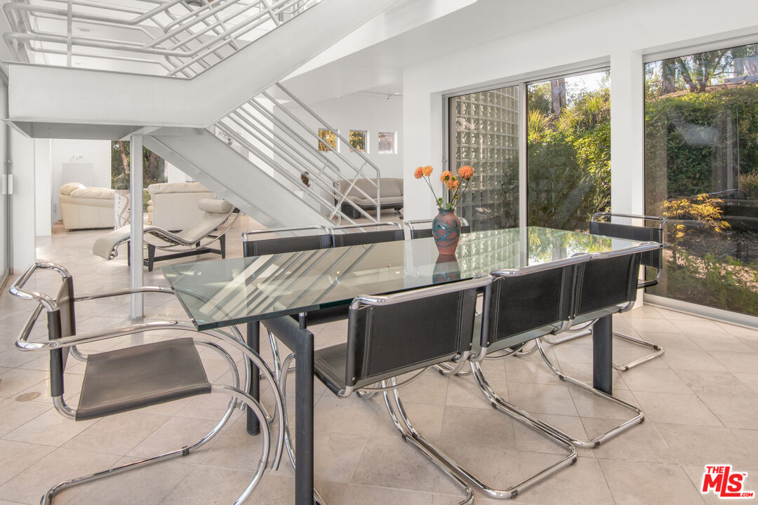 21839 Saddle Peak Road Topanga, CA 90290 - Photo 10 of 72 a dining room with furniture and a floor to ceiling window