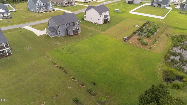 an aerial view of a house with swimming pool and ocean view