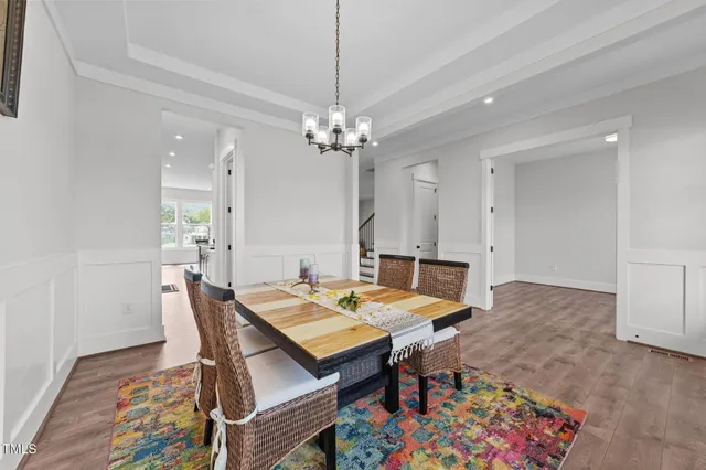 a view of a livingroom with wooden floor and staircase