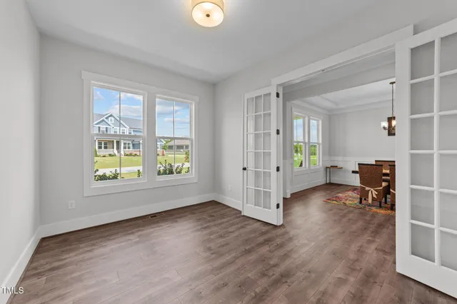 a view of kitchen with kitchen island wooden floor and living room