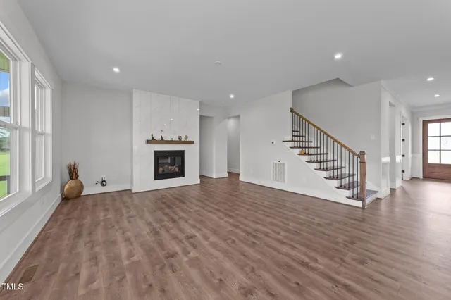 a kitchen with a stove a sink and wooden floor