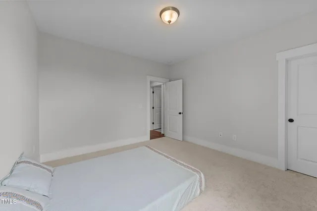 a bathroom with a granite countertop double vanity sink a mirror and a bathtub