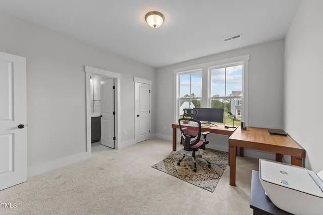 a living room with furniture a rug and a flat screen tv