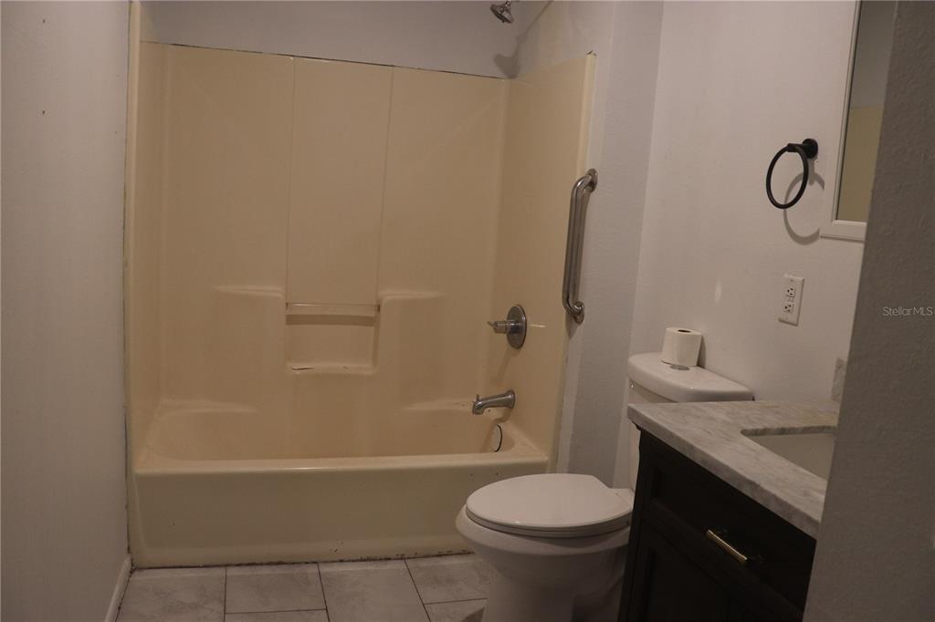 19791 Southwest 108th Lane Dunnellon, FL 34432 - Photo 17 of 19 a bathroom with a granite countertop sink toilet and shower