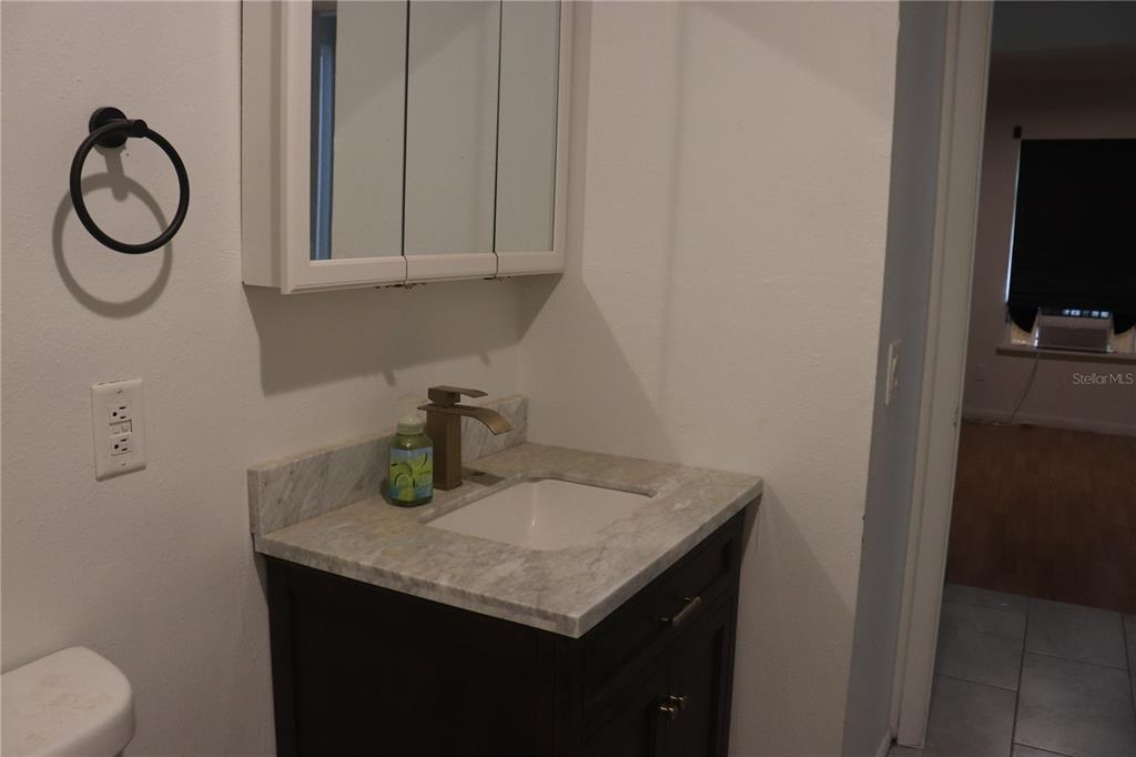 19791 Southwest 108th Lane Dunnellon, FL 34432 - Photo 18 of 19 a bathroom with a granite countertop sink and a mirror