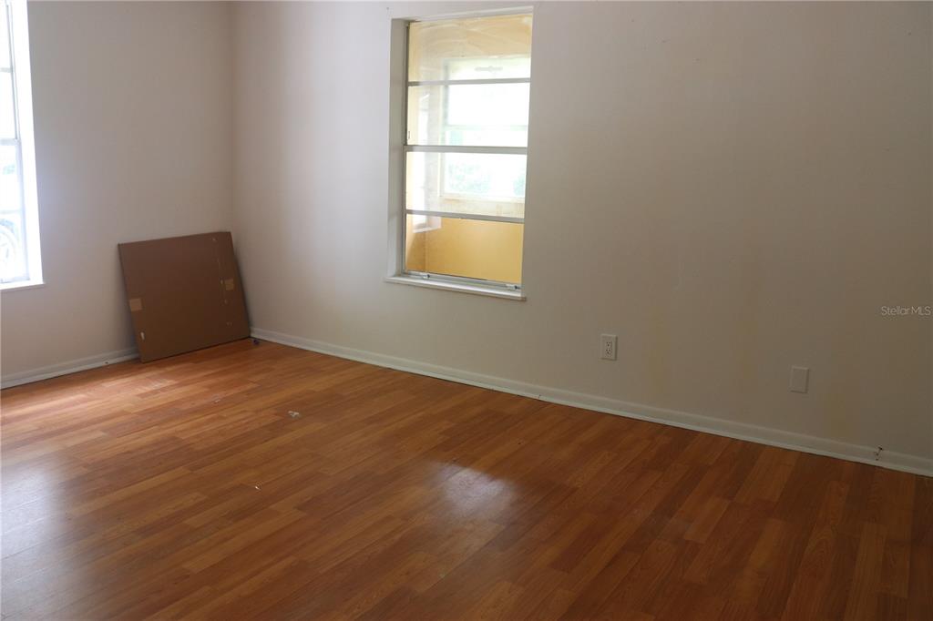 19791 Southwest 108th Lane Dunnellon, FL 34432 - Photo 19 of 19 an empty room with wooden floor and windows
