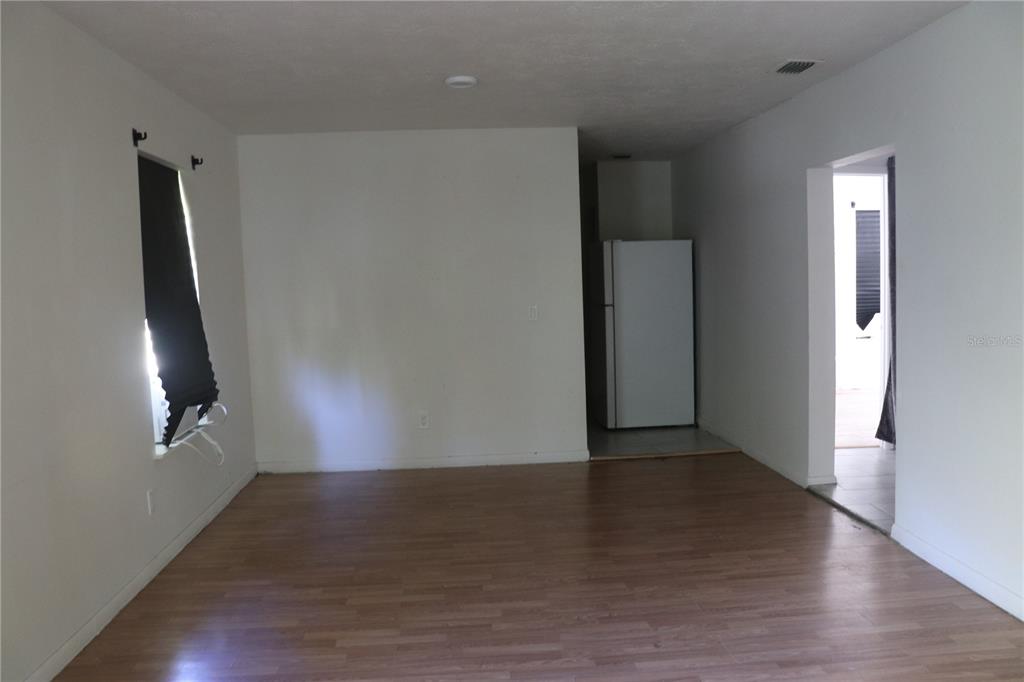 19791 Southwest 108th Lane Dunnellon, FL 34432 - Photo 5 of 19 an empty room with wooden floor and windows